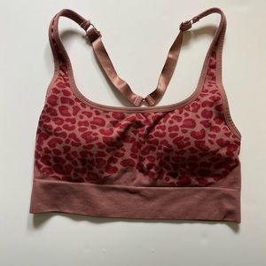 Magenta leopard print sports bra by fabletics.
